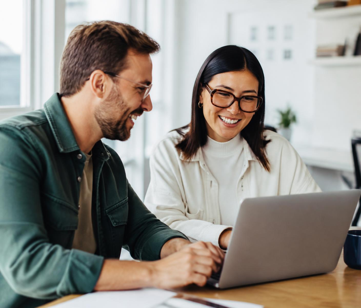 Two colleagues working together in a bright office